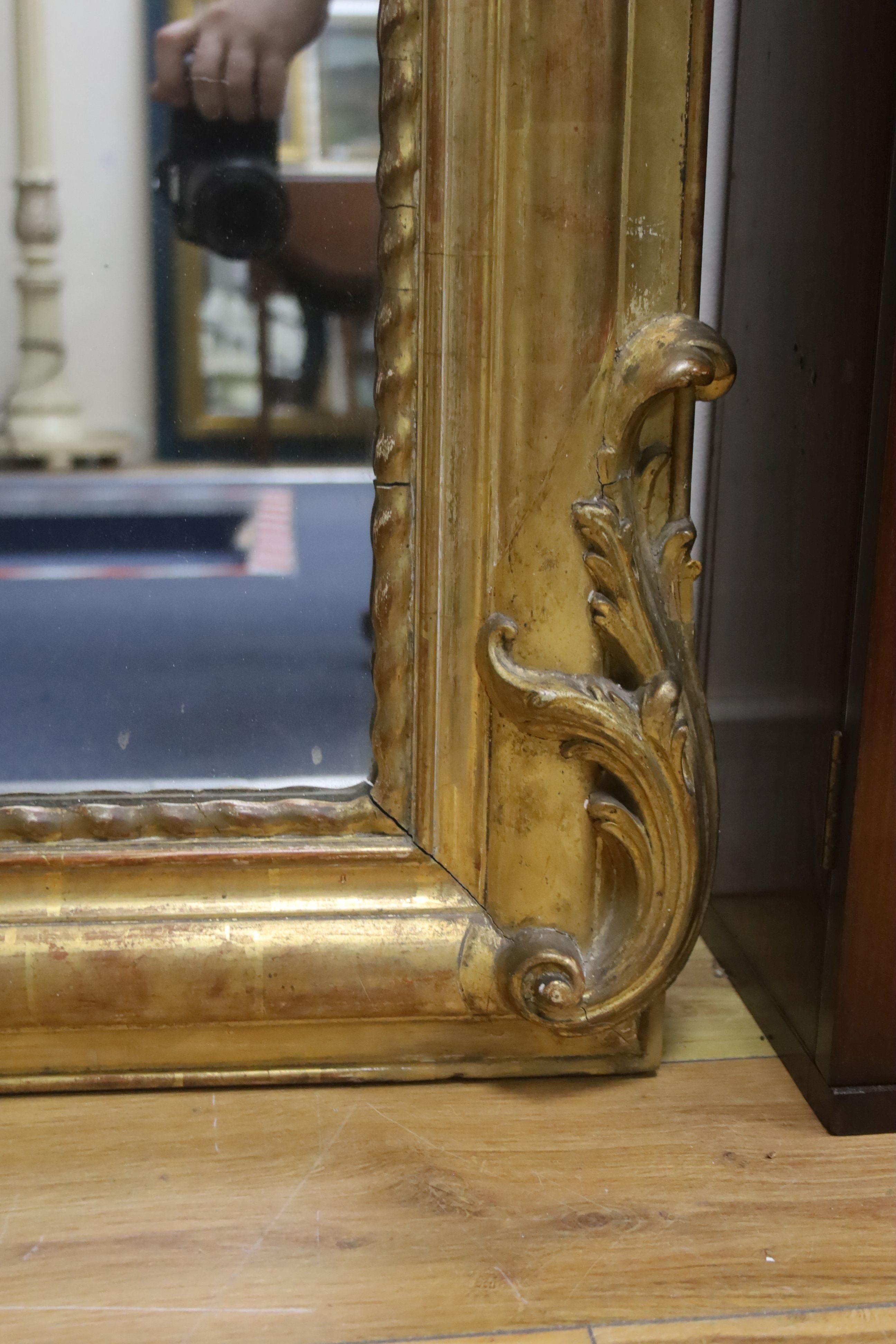 A 19th century French overmantel mirror, giltwood and gesso with channelled frame and scroll with cabochon crest detail, width 98cm, height 164cm